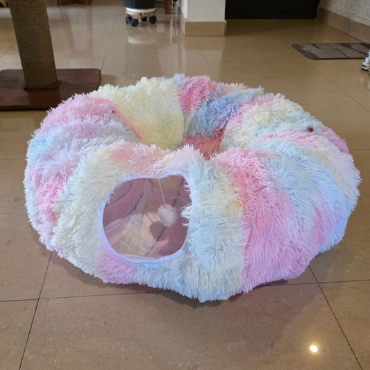Fluffy pink and white pet bed on a tiled floor